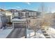 Two-story home with gray siding, stone accents, and a snow-covered yard at 10551 Applebrook Cir, Highlands Ranch, CO 80130