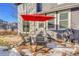 Stone patio with seating area and red umbrella at 10551 Applebrook Cir, Highlands Ranch, CO 80130