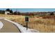 Paved path meandering through a natural landscape with light snow at 10551 Applebrook Cir, Highlands Ranch, CO 80130