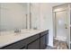 Bathroom features a double sink vanity, large mirror, and tiled shower for a spa-like experience at 1986 S Haleyville Way, Aurora, CO 80018