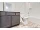 Full bathroom featuring a white vanity, toilet, bathtub with shower and modern fixtures at 1986 S Haleyville Way, Aurora, CO 80018