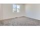 Bright bedroom with plush carpet and a large window offering views of the surrounding neighborhood at 1986 S Haleyville Way, Aurora, CO 80018