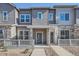 Charming townhome showcasing stone accents, gray siding, and inviting front porch perfect for relaxation at 1986 S Haleyville Way, Aurora, CO 80018