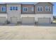 Modern townhome exteriors feature attached garages and neutral color palettes at 1986 S Haleyville Way, Aurora, CO 80018