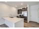 Modern kitchen featuring stainless steel appliances, white quartz countertop, and dark cabinetry at 1986 S Haleyville Way, Aurora, CO 80018