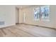 Bright living room with hardwood floors, modern white walls, and large windows, perfect for entertaining at 1986 S Haleyville Way, Aurora, CO 80018