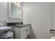 Bathroom vanity featuring a dark countertop and a white framed mirror above at 7904 Chase Cir # 146, Arvada, CO 80003