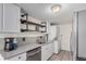 Bright kitchen with modern appliances, laundry machine and custom shelving at 7904 Chase Cir # 146, Arvada, CO 80003