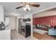 Open kitchen and living area with tiled floors and stainless steel appliances at 7904 Chase Cir # 146, Arvada, CO 80003