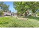 Spacious backyard with lush green grass and mature trees offering ample shade at 3246 W 53Rd Ave, Denver, CO 80221