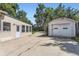 Detached garage and additional building along a concrete driveway in the backyard at 3246 W 53Rd Ave, Denver, CO 80221