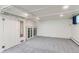 Finished basement with carpet flooring, storage, and white paneling at 3246 W 53Rd Ave, Denver, CO 80221