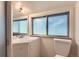 Bright bathroom featuring a vanity, mirror, and a frosted window at 3246 W 53Rd Ave, Denver, CO 80221