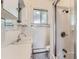 Classic white bathroom featuring a shower, sink, and a window for natural light at 3246 W 53Rd Ave, Denver, CO 80221