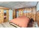 Charming bedroom featuring wood paneled walls, warm lighting, and cozy bed at 3246 W 53Rd Ave, Denver, CO 80221