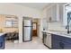 Modern kitchen with stainless steel appliances, sleek cabinets, and adjoining eating area at 3246 W 53Rd Ave, Denver, CO 80221