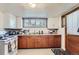 Cozy kitchen featuring natural-wood cabinets, basic appliances, and ample counter space at 3246 W 53Rd Ave, Denver, CO 80221