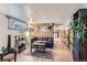Basement living room with wood-paneled walls and comfortable seating arrangement at 3246 W 53Rd Ave, Denver, CO 80221