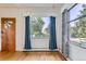 Bright living room with large windows, stylish curtains, and hardwood floors at 3246 W 53Rd Ave, Denver, CO 80221