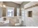 Elegant bathroom boasts glass shower with modern tile surround and recessed niche at 3171 W 38Th Ave, Denver, CO 80211