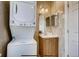 Bathroom featuring stacked washer and dryer, mirror, and vanity at 3171 W 38Th Ave, Denver, CO 80211