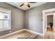 Bedroom features hardwood floors, a ceiling fan, and gray walls with white trim at 3171 W 38Th Ave, Denver, CO 80211