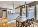 Dining area with modern chandelier, view of kitchen, and natural light at 3171 W 38Th Ave, Denver, CO 80211