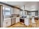 Beautiful kitchen with stainless steel appliances, mosaic backsplash, and an open layout at 3171 W 38Th Ave, Denver, CO 80211