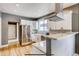 Bright kitchen with stainless steel refrigerator, granite counters, and stylish cabinets at 3171 W 38Th Ave, Denver, CO 80211