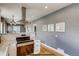 Open concept kitchen with stainless steel oven and cooktop, granite counters and modern lighting at 3171 W 38Th Ave, Denver, CO 80211