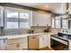 Modern kitchen boasts white cabinets, stainless steel appliances, and granite countertops at 3171 W 38Th Ave, Denver, CO 80211