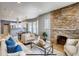 Bright living room featuring a stone fireplace, hardwood floors, and open concept design at 3171 W 38Th Ave, Denver, CO 80211