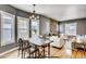 Open concept dining and living room with stone fireplace, lots of natural light and hardwood floors at 3171 W 38Th Ave, Denver, CO 80211