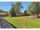 Expansive backyard with mature trees and a beautifully maintained lawn at 8262 Otis Ct, Arvada, CO 80003