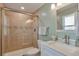 Stylish bathroom with tile surround, sleek glass shower, modern vanity, and updated fixtures at 8262 Otis Ct, Arvada, CO 80003
