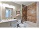 Elegant bathroom with tub and shower combo, updated vanity, and stylish decor at 8262 Otis Ct, Arvada, CO 80003