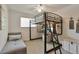 Fun bedroom features a lofted bed with desk space and a compact seating area at 8262 Otis Ct, Arvada, CO 80003