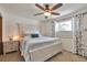 Bright main bedroom featuring a ceiling fan, nightstands and an upholstered, queen-sized bed at 8262 Otis Ct, Arvada, CO 80003
