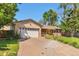 Beautiful front of the house with lush greenery, chairs on the porch, and a two car garage at 8262 Otis Ct, Arvada, CO 80003