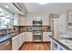 Well-equipped kitchen with stainless steel appliances, granite countertops, and wooden cabinets at 8262 Otis Ct, Arvada, CO 80003