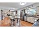 Open concept kitchen featuring stainless steel appliances, a center island with seating, and lots of cabinets at 8262 Otis Ct, Arvada, CO 80003