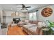 Inviting living room features a cozy fireplace, ceiling fan, and comfortable, oversized sectional sofa at 8262 Otis Ct, Arvada, CO 80003