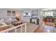 Spacious living room features a cozy couch, wood floors, and open access to the dining area at 8262 Otis Ct, Arvada, CO 80003