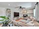 Spacious living room with fireplace, large sectional sofa, and a view into the yard at 8262 Otis Ct, Arvada, CO 80003