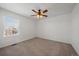 Bright bedroom with carpet flooring, fan with lights and large window providing natural light at 9608 Albion Ln, Thornton, CO 80229