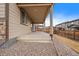 Covered back patio with brown trim and a concrete porch, perfect for outdoor entertaining at 9608 Albion Ln, Thornton, CO 80229