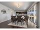 Stylish dining area, adjacent to the kitchen with a sliding door to the exterior, bathed in natural light at 9608 Albion Ln, Thornton, CO 80229