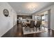 Elegant dining area with modern lighting, seamlessly connects to the kitchen and patio, ideal for entertaining at 9608 Albion Ln, Thornton, CO 80229