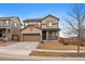 Two-story home showcasing a manicured lawn, complemented by a two-car garage and appealing modern architecture at 9608 Albion Ln, Thornton, CO 80229