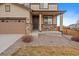 Welcoming front entrance featuring stone accents, a covered porch, and a well-maintained landscape at 9608 Albion Ln, Thornton, CO 80229